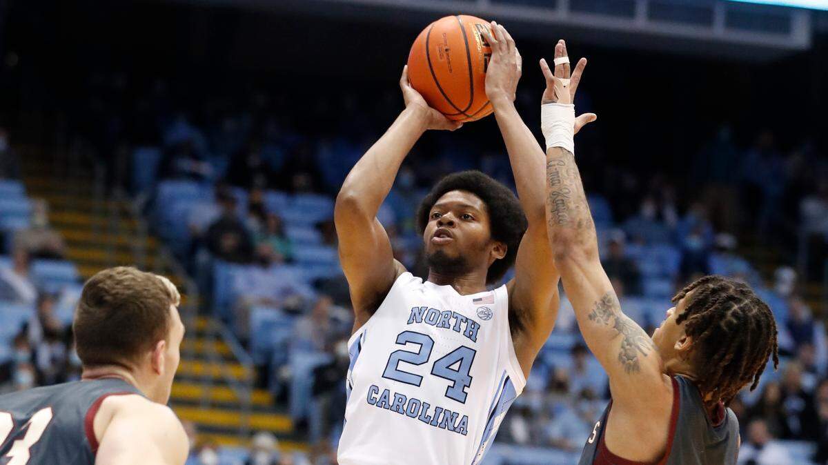 North Carolina’s Kerwin Walton (24) shoots as Boston College’s Makai Ashton-Langford (11) defends during the first half of UNC’s game against Boston College at the Smith Center in Chapel Hill, N.C., Wednesday, Jan. 26, 2022.