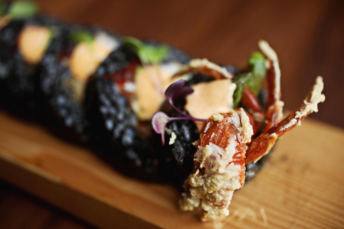 The Black Widow roll wraps soft shell crab, snow crab and avocado in a shroud of squid ink rice as black as its name at O-Ku Sushi in Raleigh.