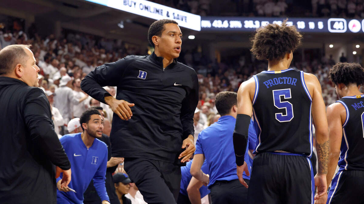 Justin Robinson, center left, Duke basketball’s director of player development, heads to the bench area as a timeout is called during the second half of Arkansas’ 80-75 victory over Duke at Bud Walton Arena in Fayetteville, Ark., Weds. Nov. 29, 2023. Robison is a former player for Duke, playing from 2016-2020.