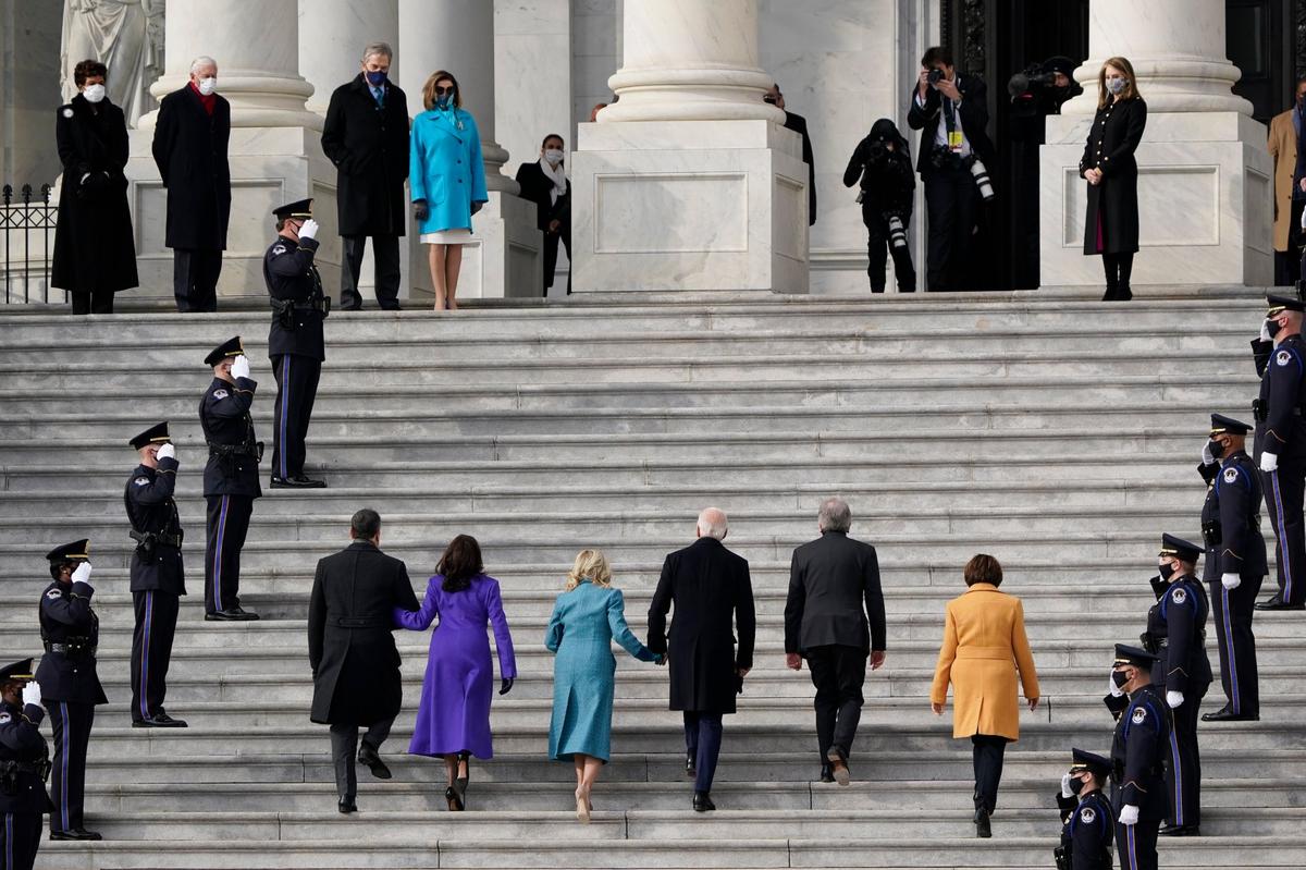 President-elect Joe Biden, his wife Jill Biden and Vice President-elect Kamala Harris and her husband Doug Emhoff arrive at the steps of the U.S. Capitol for the start of the official inauguration ceremonies, in Washington, Wednesday, Jan. 20, 2021. Speaker of the House, Nancy Pelosi waits at left.
