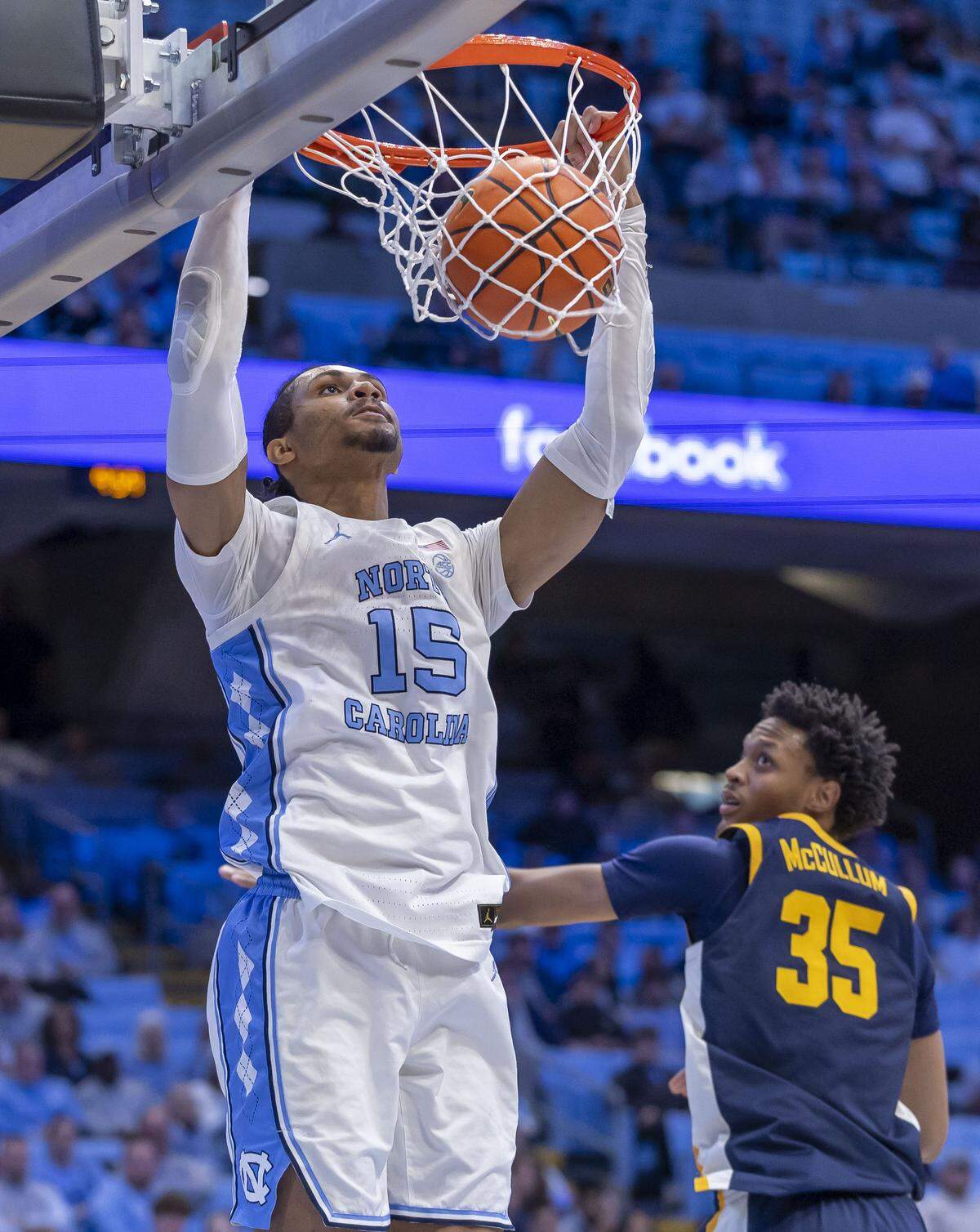 North Carolina forward Jarin Stevenson (15) gets a dunk over East Tennessee State forward Jordan McCullum (35) in the second half on Tuesday, December 16, 2025 at the Smith Center in Chapel Hill, N.C.