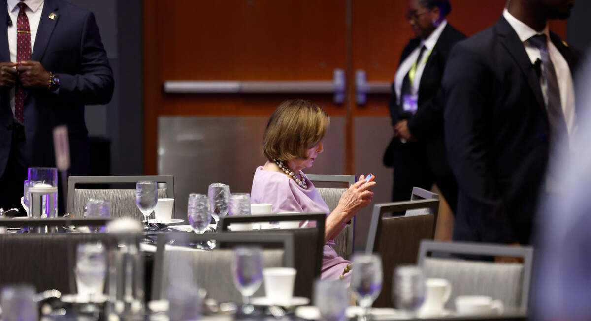 Former Democratic U.S. House Speaker Nancy Pelosi checks her phone before the North Carolina Democratic Party Unity Dinner at the Raleigh Convention Center Saturday, July 20, 2024