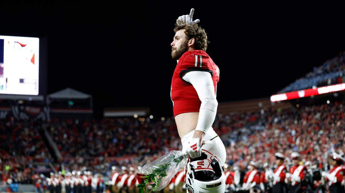 N.C. State linebacker Payton Wilson (11) acknowledges the crowd after he was introduced on senior day before the Wolfpack’s game against UNC at Carter-Finley Stadium in Raleigh, N.C., Saturday, Nov. 25, 2023.