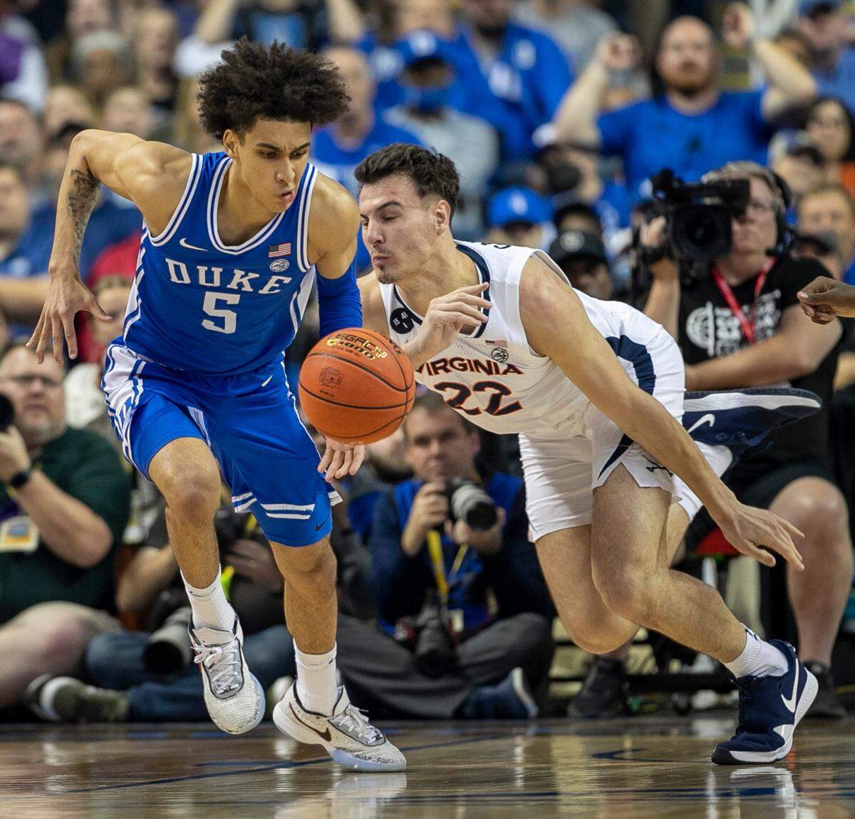 Duke’s Tyrese Proctor (5) makes a steal from Virginia’s Francisco Caffaro (22) during the first half in the championship game of the ACC Tournament on Saturday, March 11, 2023 at the Greensboro Coliseum in Greensboro, N.C