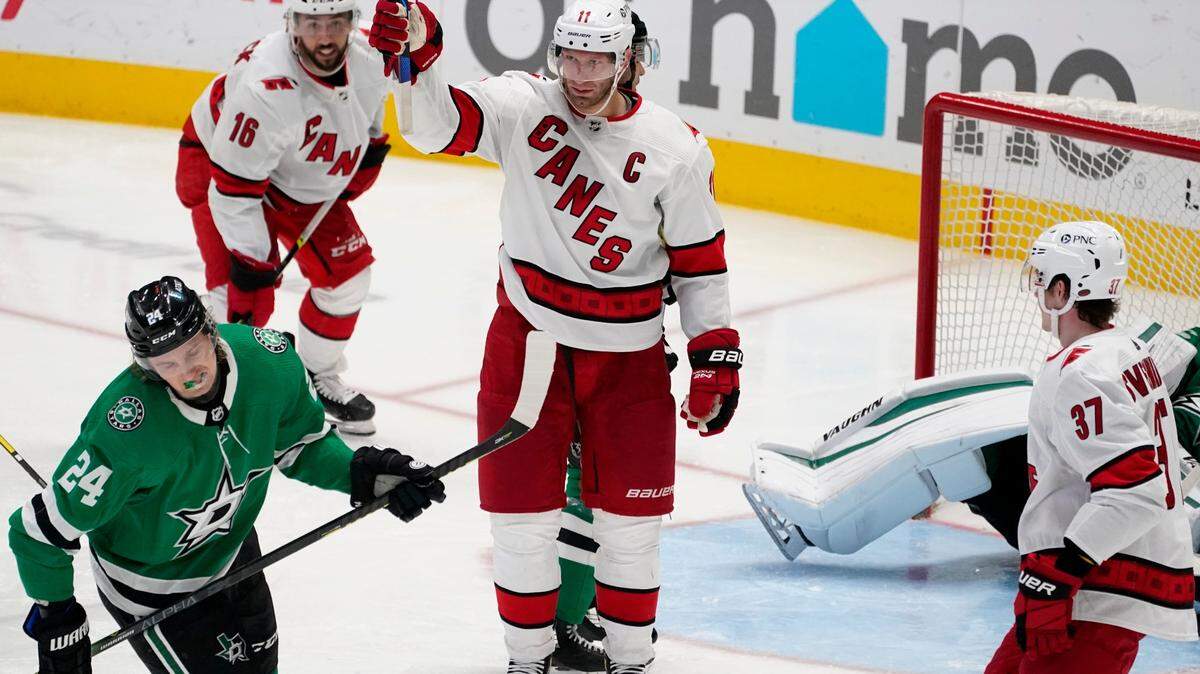 Dallas Stars left wing Roope Hintz (24) skates away as Carolina Hurricanes’ Jordan Staal (11) celebrates scoring in the second period of an NHL hockey game in Dallas, Tuesday, April 27, 2021. The Hurricanes’ Vincent Trocheck (16) and Andrei Svechnikov (37) skate to join the celebration. (AP Photo/Tony Gutierrez)