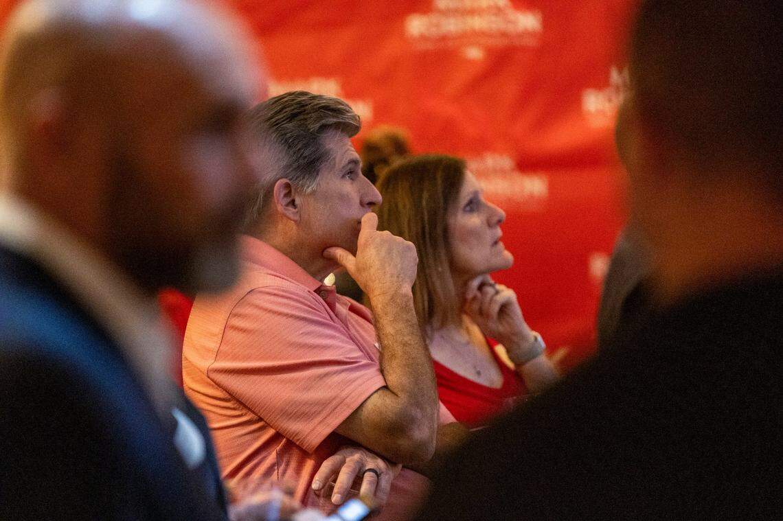 Supporters of Republican gubernatorial candidate Lt. Gov. Mark Robinson check poll results before Robinson made a concession speech during an election watch party at the City Club in Raleigh after loosing the North Carolina gubernatorial race to Democratic nominee Attorney General Josh Stein on Election Day, Tuesday, Nov. 5, 2024.