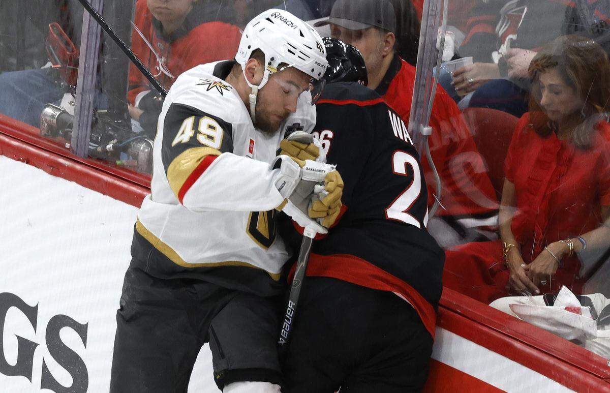 Vegas’ Ivan Barbashev (49) checks Carolina's Sean Walker (26) in the first period of the Hurricanes’ game against the Golden Knights in the second game of the Stanley Cup Final at the Lenovo Center in Raleigh, N.C., Thursday, June 4, 2026.