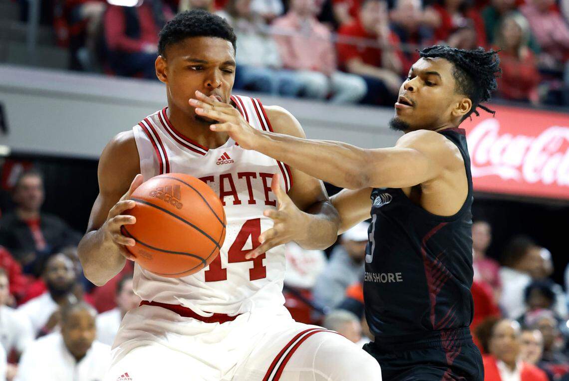 N.C. State’s Casey Morsell (14) is fouled by Maryland Eastern Shore’s Elijah Wilson (3) during the second half of N.C. State’s 93-61 victory over Maryland Eastern Shore at Reynolds Coliseum in Raleigh, N.C., Wednesday, Dec. 6, 2023.