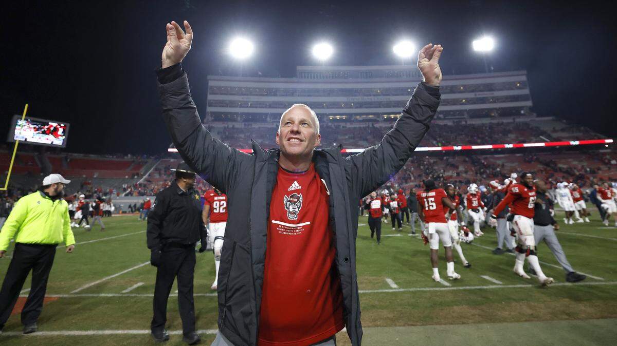 N.C. State head coach Dave Doeren celebrates after N.C. State’s 42-19 victory over UNC at Carter-Finley Stadium in Raleigh, N.C., Saturday, Nov. 29, 2025.