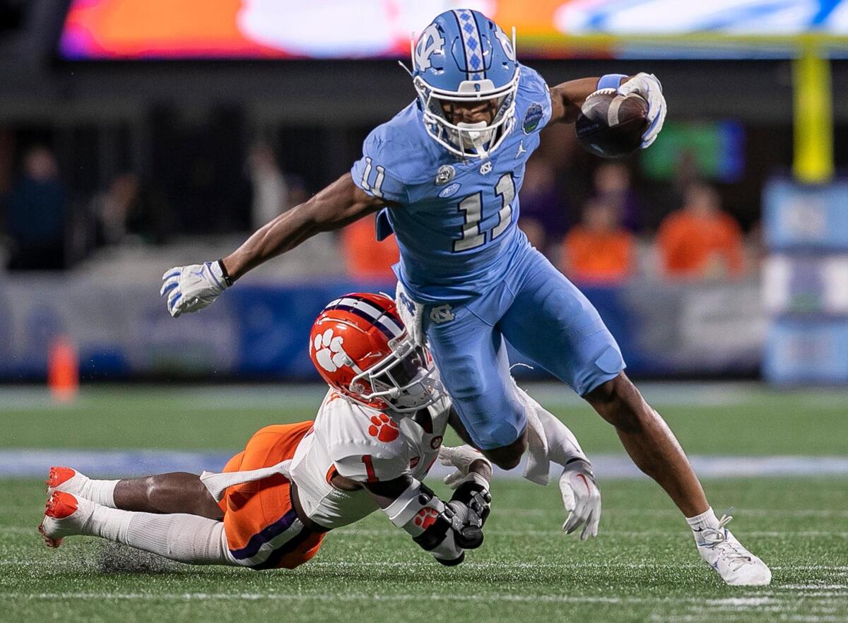 Clemson’s Cade Mukuba (1) works to stop North Carolina’s Josh Downs after an 11-yard gain on a pass reception from Drake Maye in the second quarter on Saturday, December 3, 2022 at Bank of American Stadium in Charlotte, N.C.