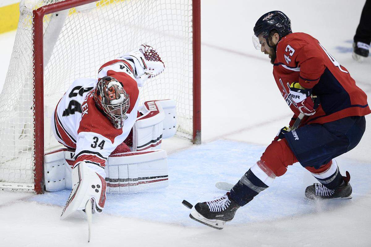 Washington Capitals right wing Tom Wilson (43) chases the puck against Carolina Hurricanes goaltender Petr Mrazek (34), of the Czech Republic, during the third period of Game 2 of an NHL hockey first-round playoff series, Saturday, April 13, 2019, in Washington. The Capitals won 4-3 in overtime.