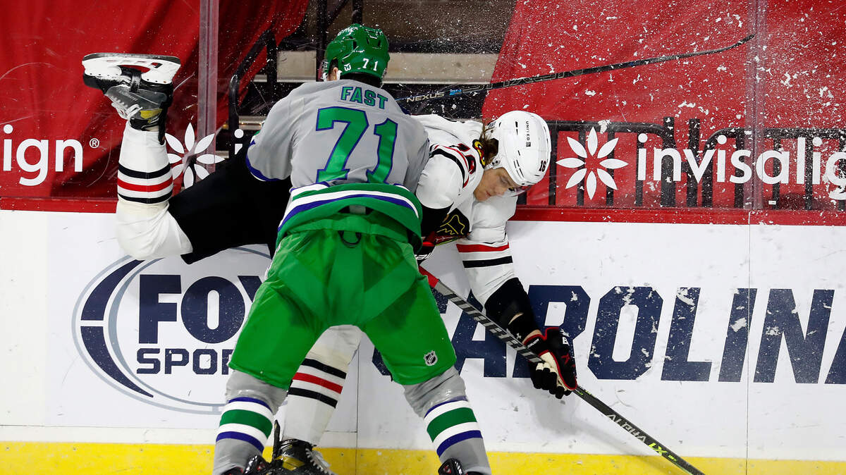 Carolina Hurricanes forward Jesper Fast (71) checks Chicago Blackhawks defenseman Nikita Zadorov (16) into the boards during the second period of an NHL hockey game in Raleigh, N.C., Friday, Feb. 19, 2021.