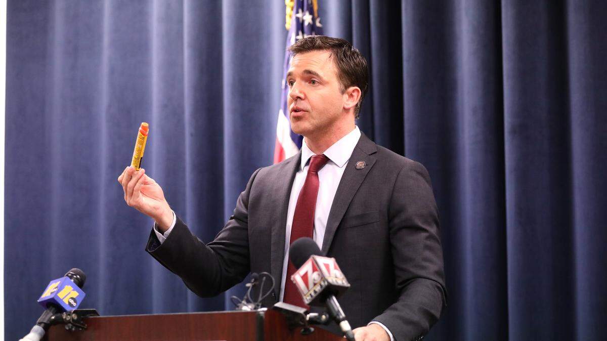 North Carolina Attorney General Jeff Jackson holds an EpiPen Auto-Injector at a press conference on Thursday, April 30, 2026. The EpiPen is marketed and distributed by pharmaceutical company Mylan, which the NC Department of Justice settled with for $11 million after alleging anti-competitive practices.