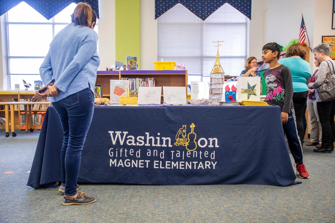 A prospective parent reviews materials at Washington Magnet Elementary School during their Magnet Theme Showcase where parents learn about what the school may offer their child if they are accepted, on Tuesday, Jan. 14, 2020, in Raleigh, N.C.