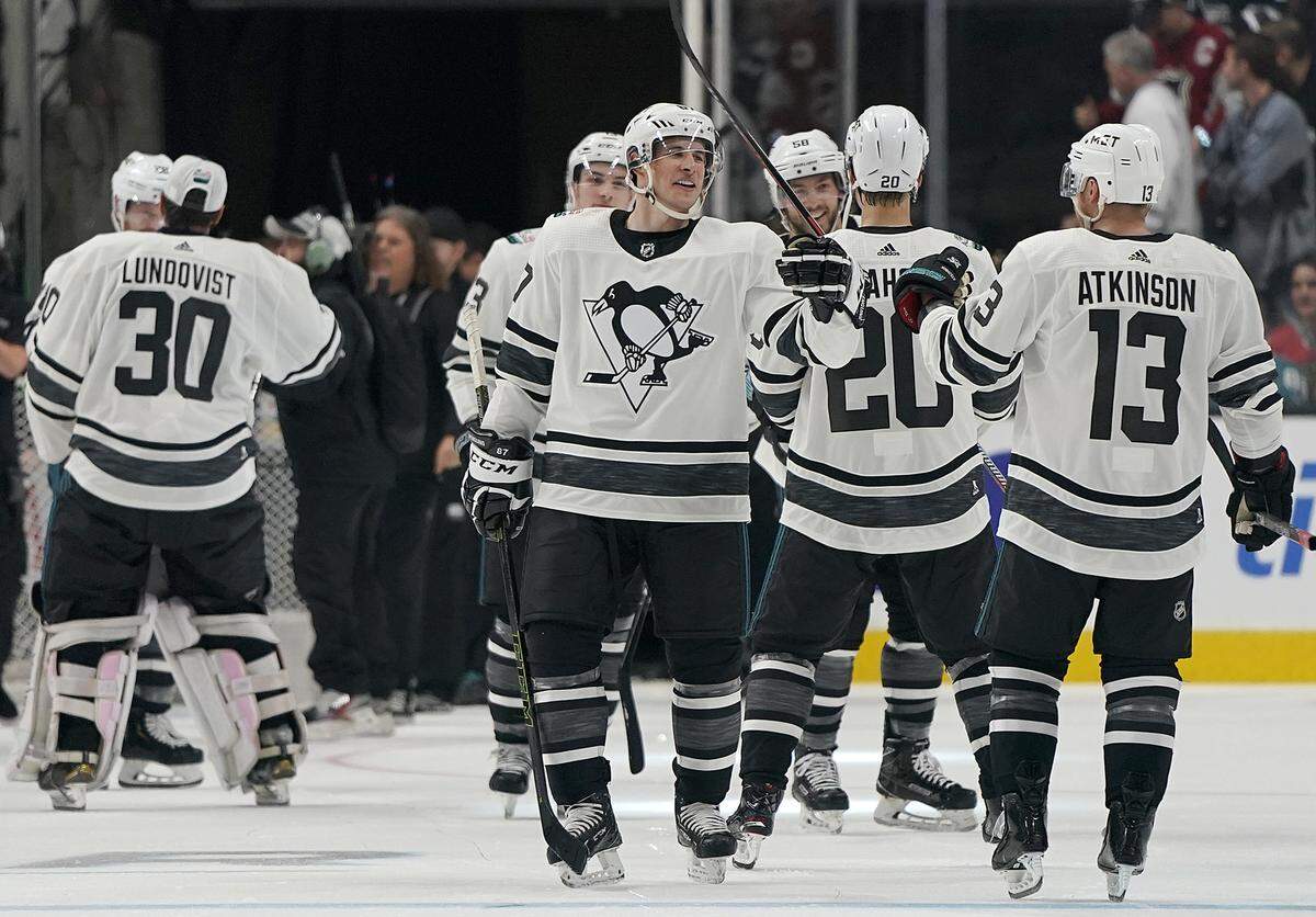 Metropolitan Division’s Sidney Crosby, center, of the Pittsburgh Penguins, celebrates with Sebastian Aho of the Carolina Hurricanes and Cam Atkinson of the Columbus Blue Jackets, after the Metropolitan Division defeated the Central Division 10-5 in the NHL hockey All-Star Game final in San Jose, Calif., Saturday, Jan. 26, 2019.