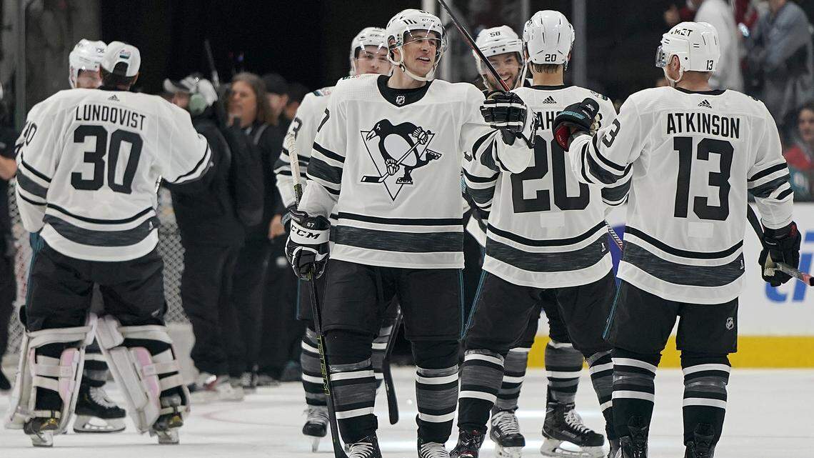 Metropolitan Division’s Sidney Crosby, center, of the Pittsburgh Penguins, celebrates with Cam Atkinson, of the Columbus Blue Jackets, after the Metropolitan Division defeated the Central Division 10-5 in the NHL hockey All-Star Game final in San Jose, Calif., Saturday, Jan. 26, 2019. (AP Photo/Tony Avelar)