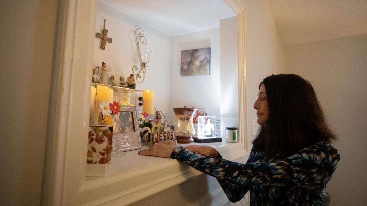 Laura S. Baker looks at a framed photograph of her daughter, Veronica Baker, at her home in Raleigh, N.C. on Friday, Jan. 20, 2023. Veronica Baker was fatally shot in August 2020.