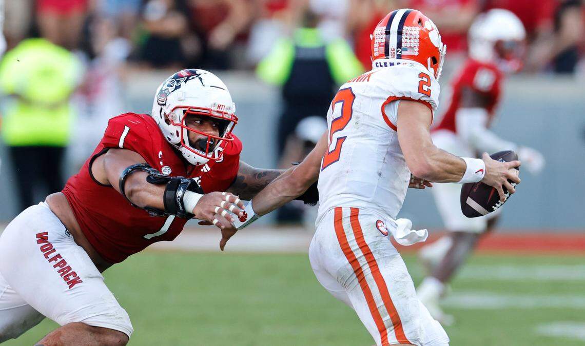 N.C. State defensive tackle Davin Vann (1) chases down Clemson quarterback Cade Klubnik (2) to sack him late in the second half of N.C. State’s 24-17 victory over Clemson at Carter-Finley Stadium in Raleigh, N.C., Saturday, Oct. 28, 2023.