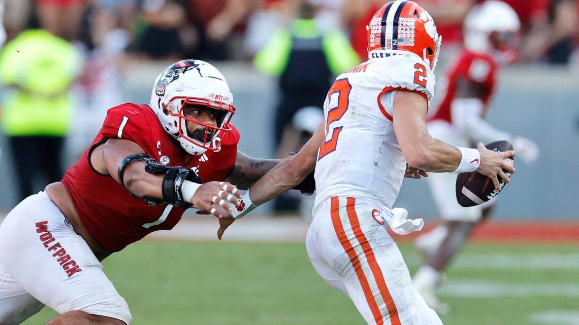 N.C. State defensive tackle Davin Vann (1) chases down Clemson quarterback Cade Klubnik (2) to sack him late in the second half of N.C. State’s 24-17 victory over Clemson at Carter-Finley Stadium in Raleigh, N.C., Saturday, Oct. 28, 2023.