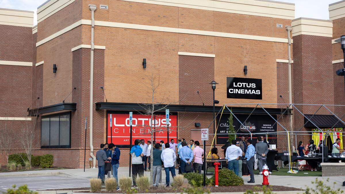 Attendees gather for a “First Look at Lotus Cinemas” event on Saturday, March 19, 2022 outside the new theater in Cary’s Parkside Town Commons shopping center.