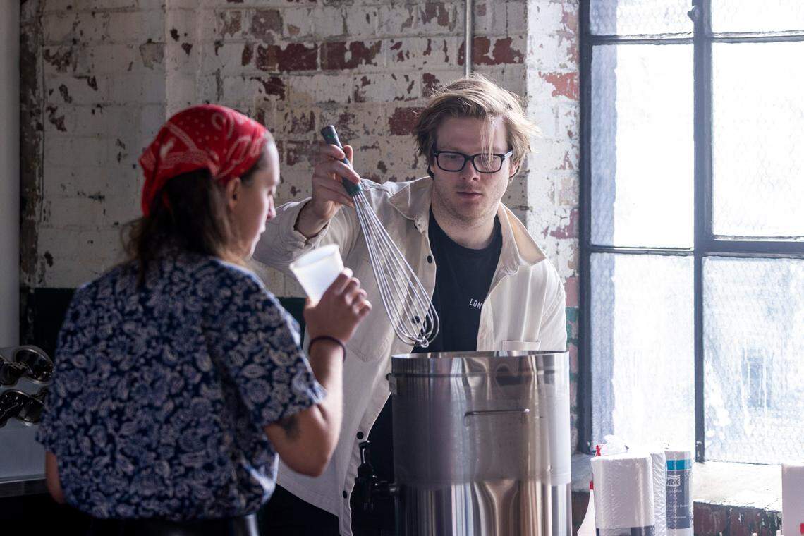 Ray Hall mixes sweet tea during the opening of Longleaf Swine in Raleigh Friday, Nov. 4, 2022.