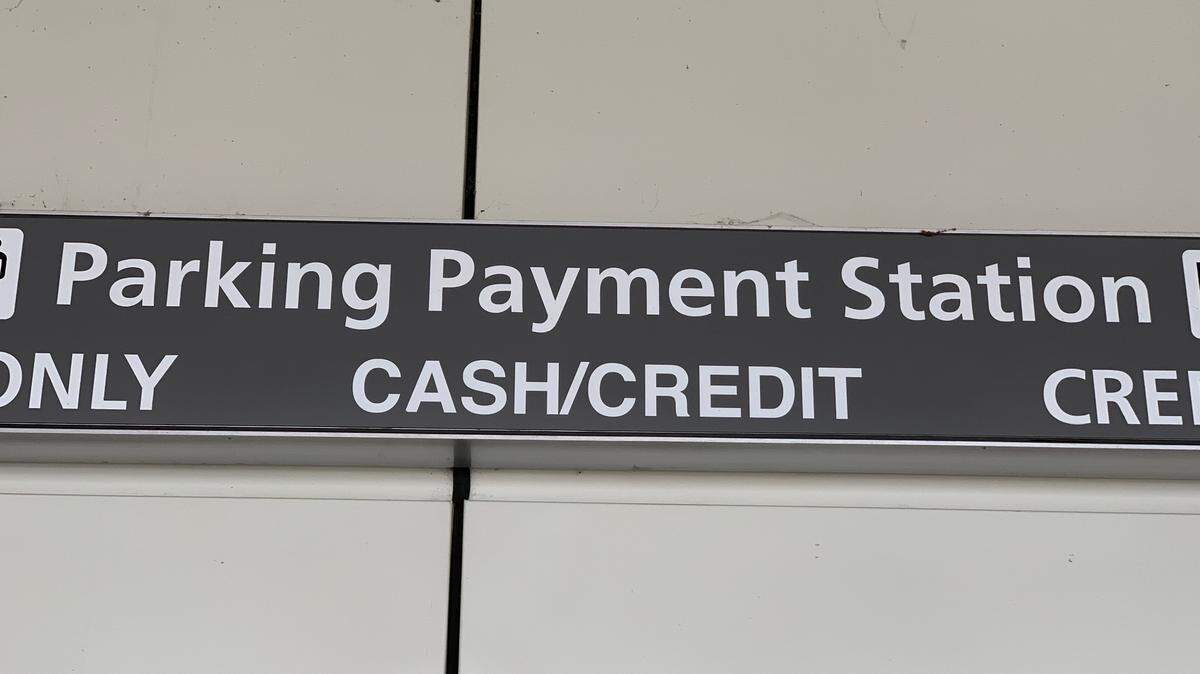 One of the parking payment kiosks outside Terminal 2 at Raleigh-Durham International Airport says it takes cash or credit, but cash is no longer an option.