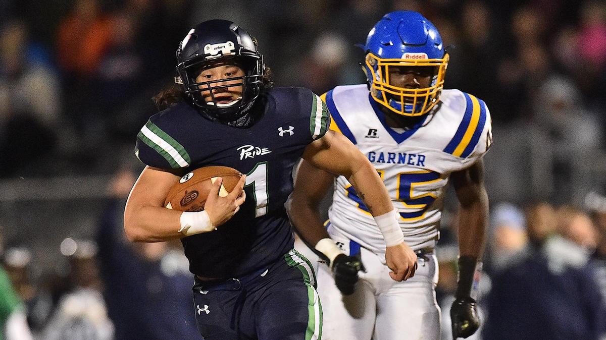 Leesville’s David Sohn (1) runs for yardage ahead of Garner’s Rayvon Fussell (45). The Leesville Road Pride and the Garner Trojans met in the NCHSAA 4AA third round football playoffs in Raleigh, N.C. on November 29, 2019.