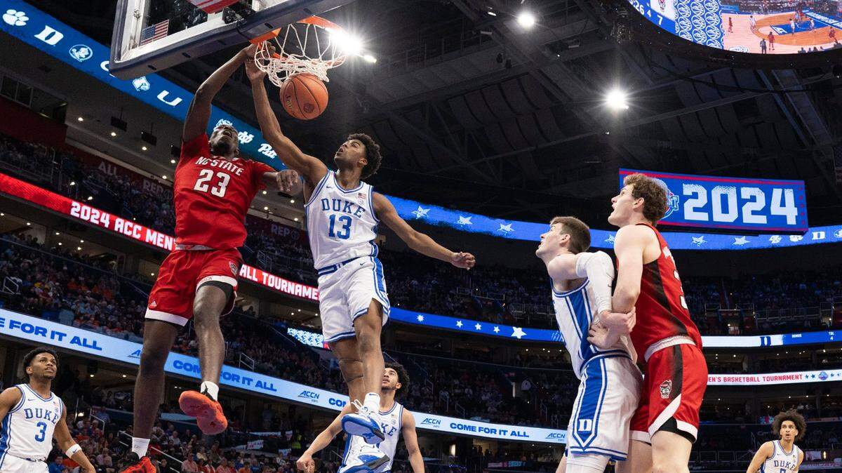 N.C. State’s Casey Morsell (14) and Mohamed Diarra (23) defend Duke’s Tyrese Proctor (5) in the second half during the quarterfinals of the ACC Men’s Basketball Tournament at Capitol One Arena on Wednesday, March 13, 2024 in Washington, D.C.