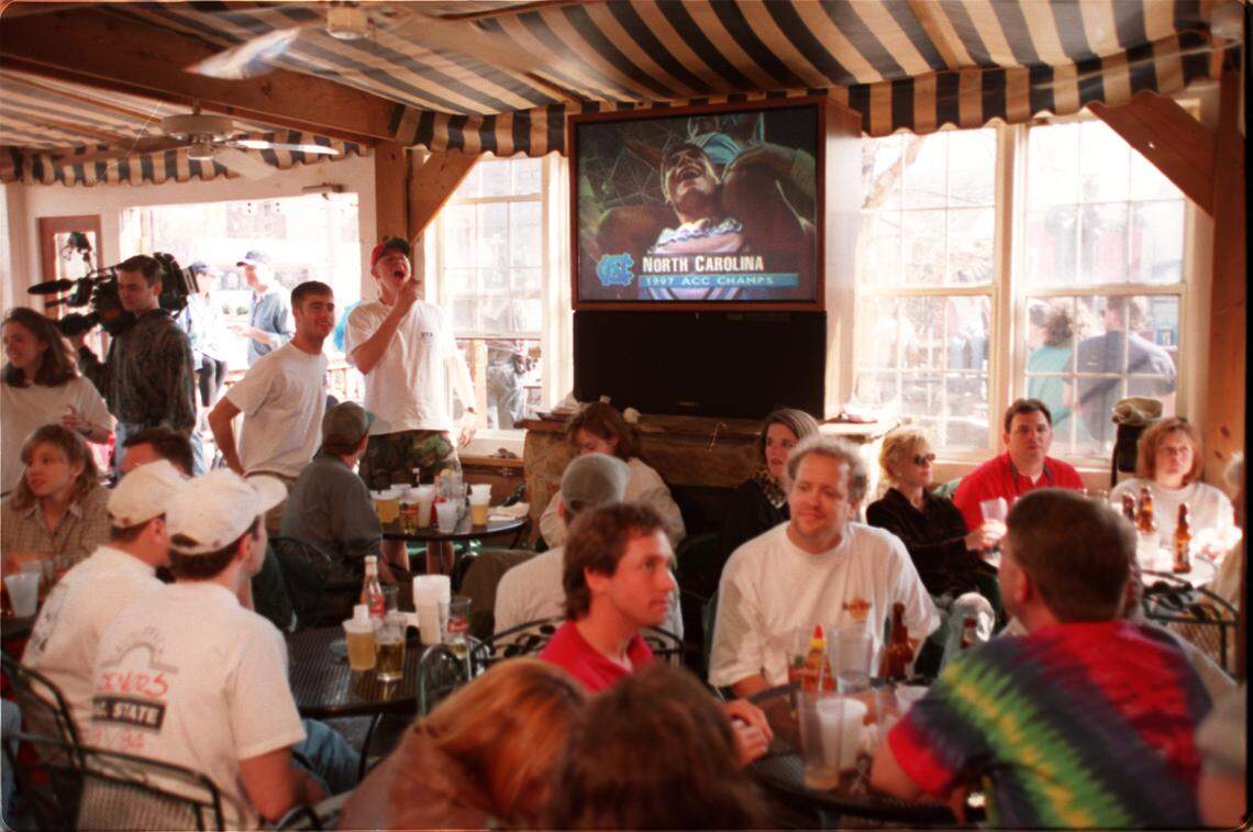 State fans sit in shock at East Village on Hillsborough Street after State’s loss to Carolina in 1997.
