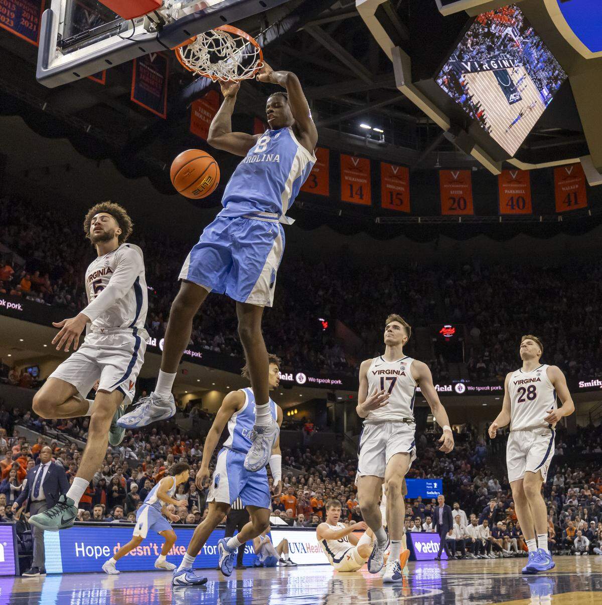 North Carolina forward Caleb Wilson (8) breaks to the basket for a dunk  against Virginia’s Sam Lewis (5) in the second half on Saturday, January 24, 2026 at John Paul Jones Arena in Charlottesville, Va. Wilson scored 20 points in the Tar Heels’ 85-80 victory. 