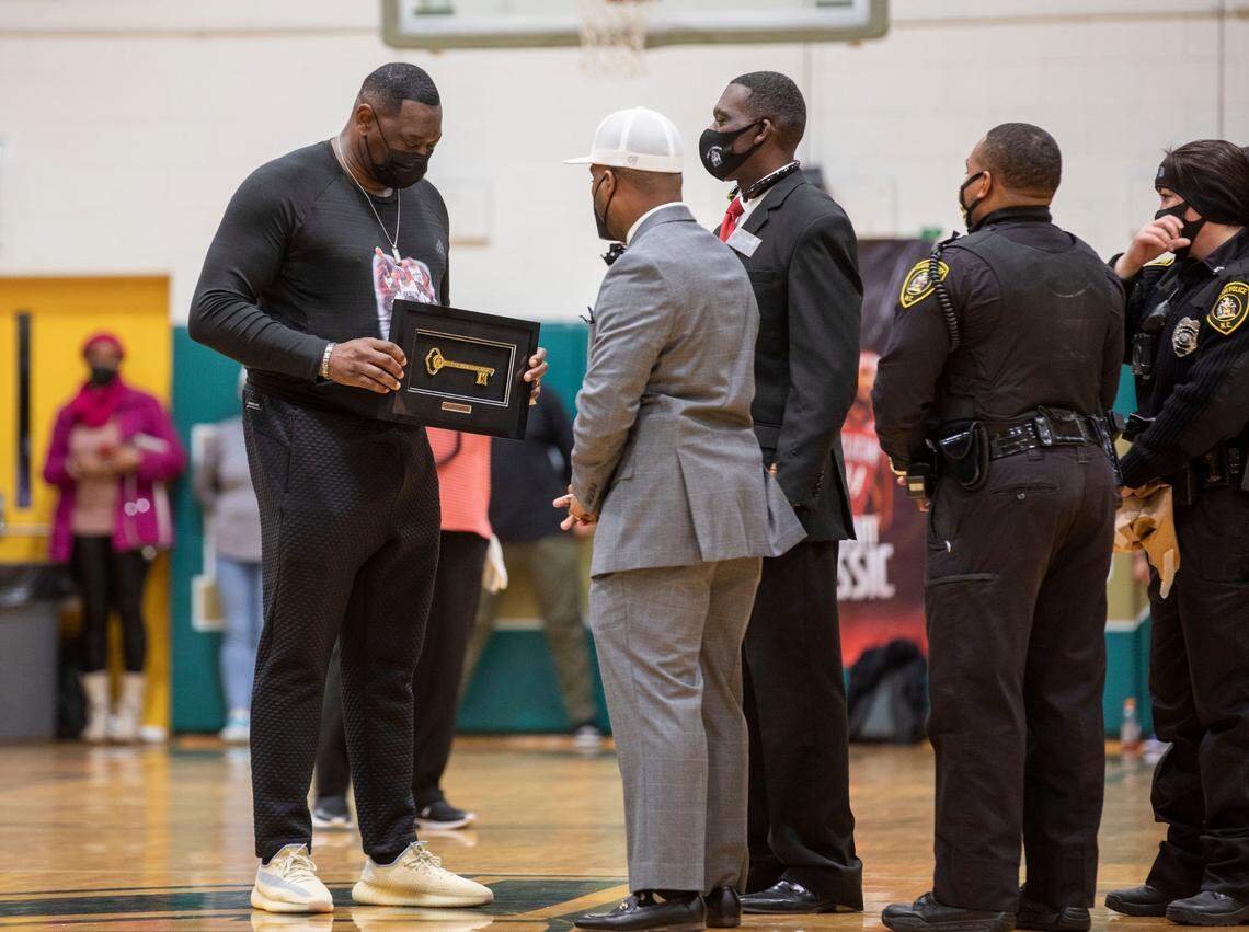 Donald Ingram, left, the father of NBA player Brandon Ingram, is awarded a key to the city of Kinston, N.C. by Kinston Mayor Don Hardy, middle, and Mayor Pro Tem Antonio Hardy, middle right, during the inaugural Brandon Ingram MLK Showcase in Kinston, N.C. on Saturday, Jan. 15, 2022.