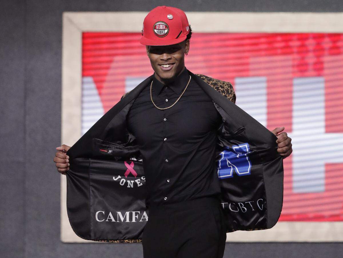 Duke’s Cam Reddish shows off his jacket after the Atlanta Hawks selected him as the 10th overall pick in the NBA basketball draft Thursday, June 20, 2019, in New York.
