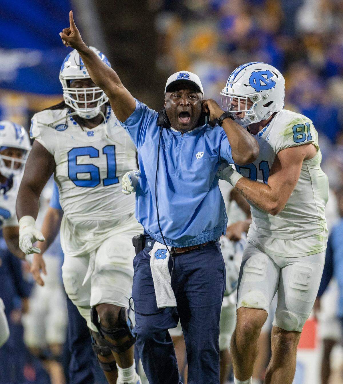North Carolina special teams coach Larry Porter celebrates after a 52-yards punt return by Alijah Huzzie (28) to give the Tar Heels a 21-14 lead over Pitt in the second quarter on Saturday, September 23, 2023 at Acrisure Stadium in Pittsburgh, Pa.