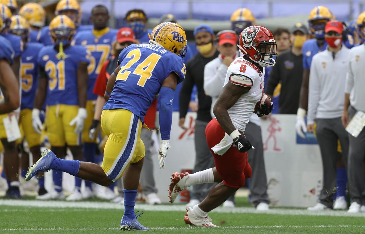N.C. State’s Ricky Person Jr. (8) runs the ball as Pittsburgh Panthers linebacker Phil Campbell III (24) chases during the first quarter at Heinz Field.