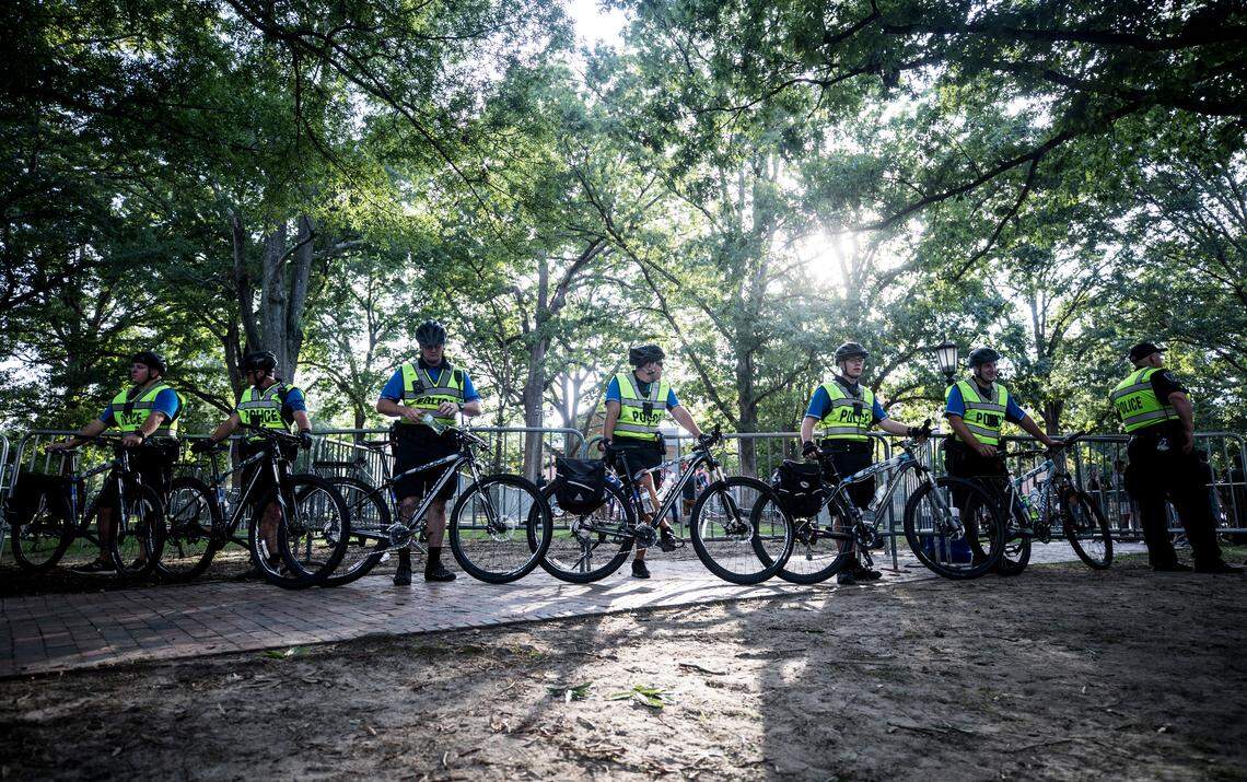UNC-Chapel Hill police officers guard the front of a designated barricade where pro-Confederate demonstrators waved Confederate flags and engaged with protesters from afar on Saturday, September 8, 2018.