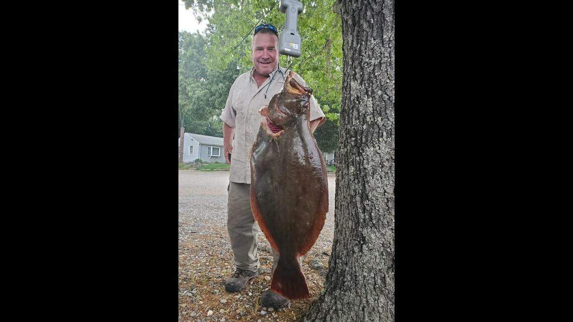Bill Proulx and the summer flounder he caught.