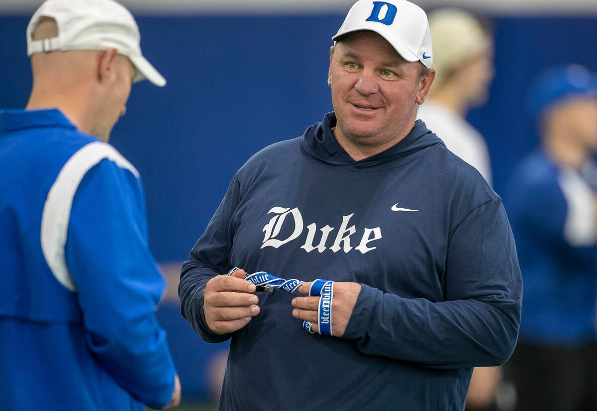 Duke head coach Mike Elko talks with offensive coordinator Kevin Johns during the Blue Devils’ spring practice on Friday, March 24, 2023 in Durham, N.C.