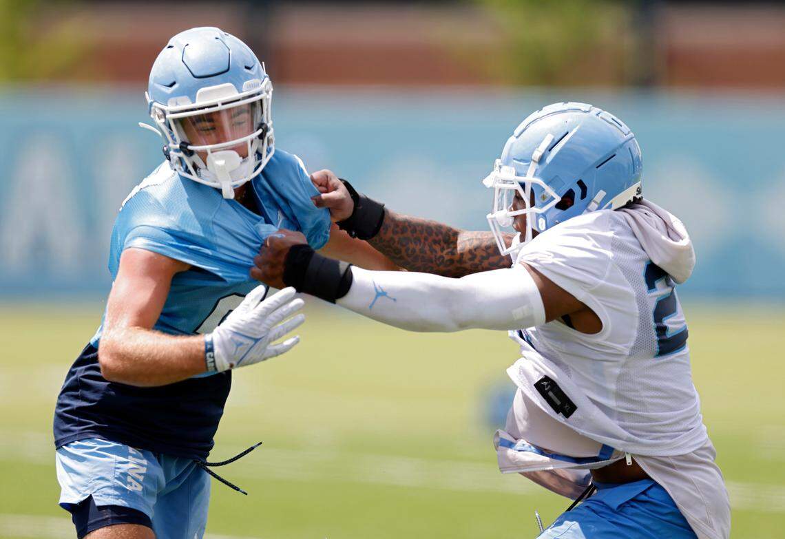 North Carolina linebacker Power Echols, right, runs a drill against North Carolina wide receiver Brooks Miller during UNC’s first football practice of the season on Friday, July 29, 2022, in Chapel Hill, N.C.