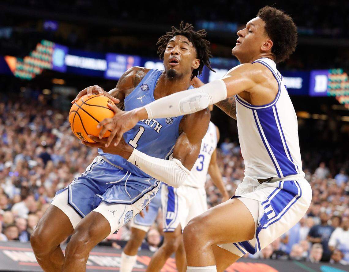 North Carolina’s Leaky Black (1) drives past Dukes Paolo Banchero (5) during the first half of Dukes game against UNC in the Final Four at Caesars Superdome in New Orleans, La., Saturday, April 2, 2022.
