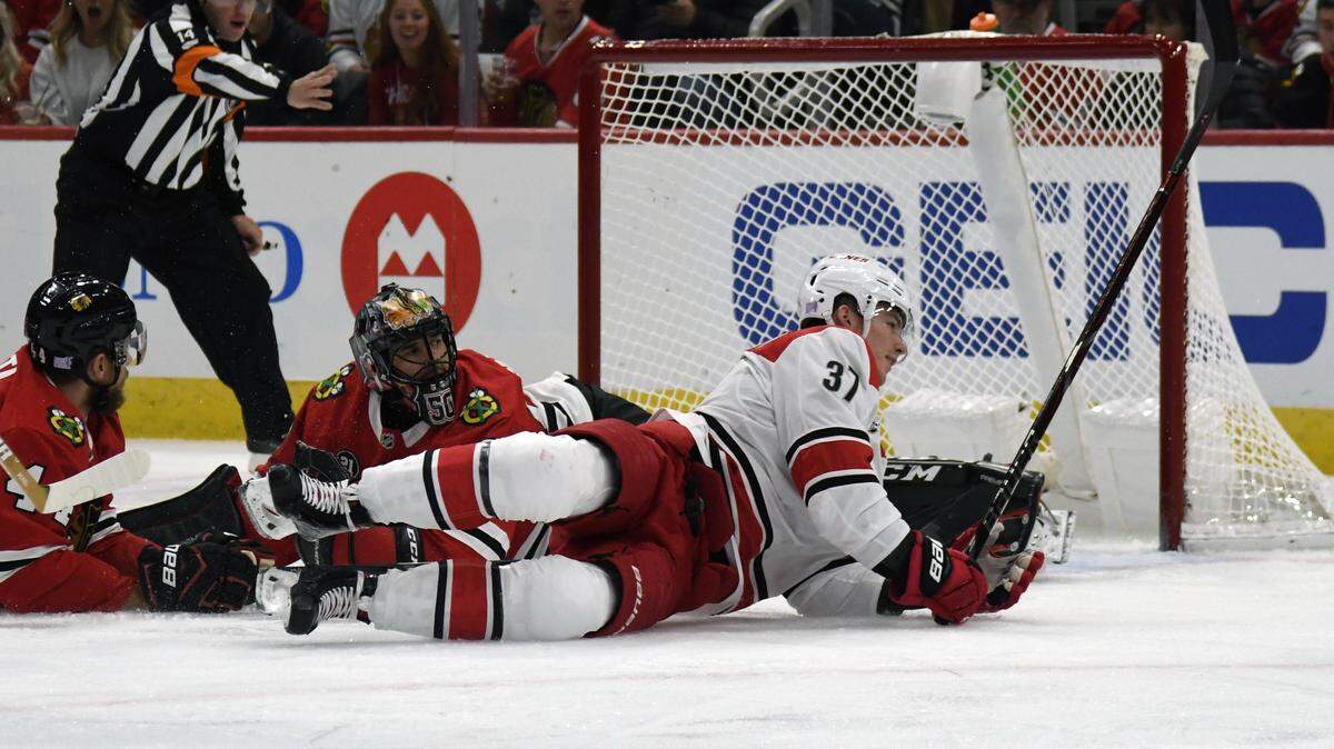 Carolina Hurricanes right wing Andrei Svechnikov (37) scores a goal on Chicago Blackhawks goaltender Corey Crawford (50) during the first period of an NHL hockey game Thursday, Nov. 8, 2018, in Chicago. (AP Photo/David Banks)
