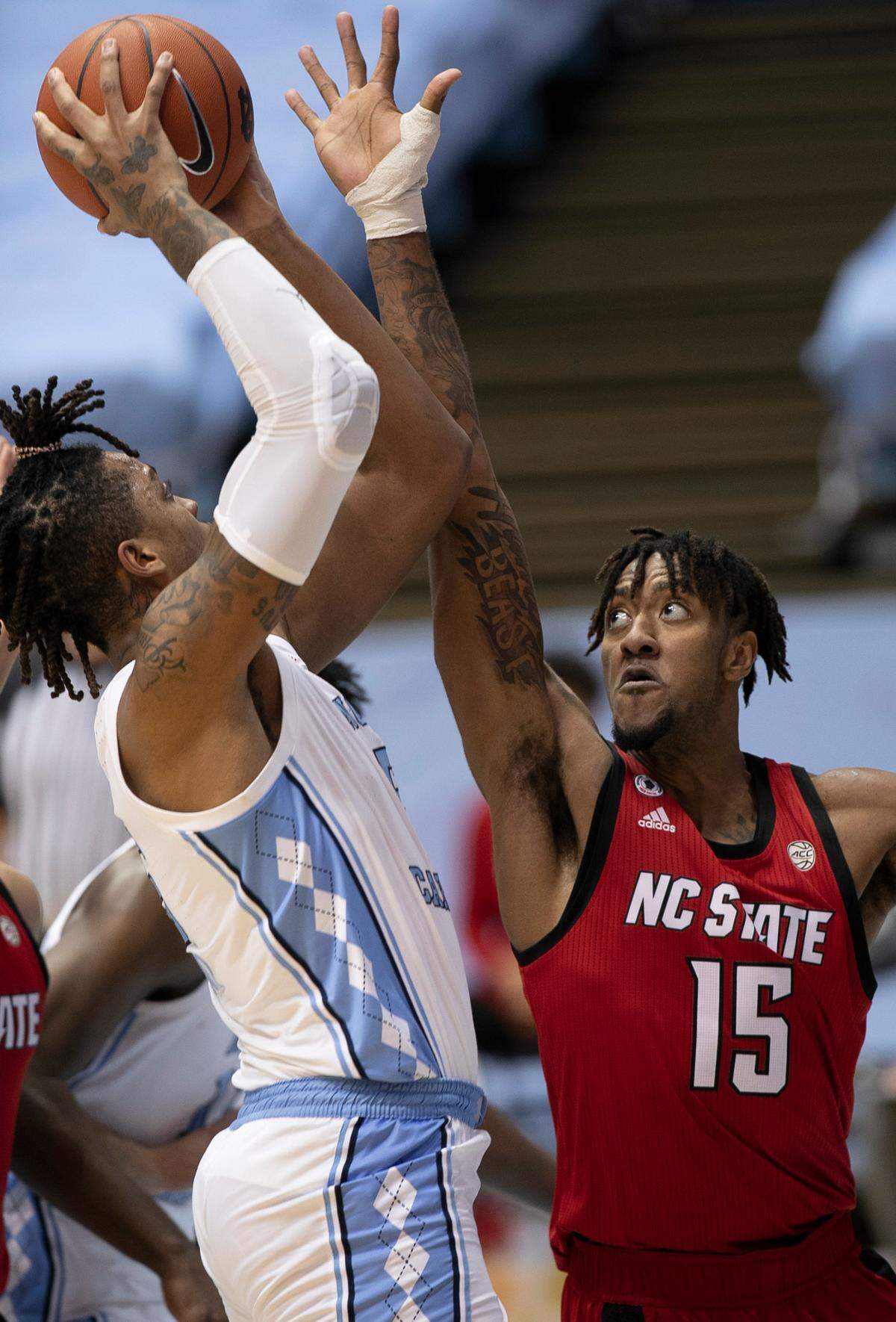 N.C. State’s Manny Bates (15) defends North Carolina’s Armando Bacot (5) in the first half on Saturday, January 23, 2021 at the Smith Center in Chapel Hill, NC.