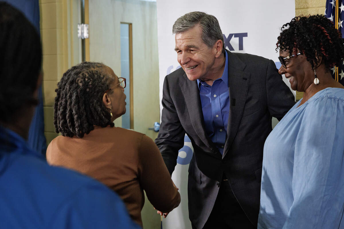 Former Gov. Roy Cooper greets Rev. Kim Moss and Dianne Fowler following a  “Make Stuff Cost Less” campaign rally at the Graham Civic Center on Monday, July 13, 2026, in Graham, N.C.