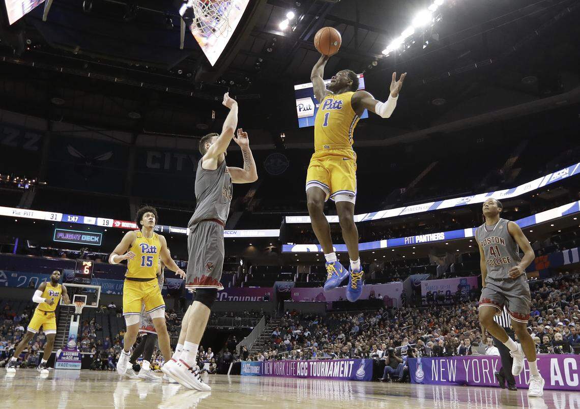 Pittsburgh’s Xavier Johnson (1) drives to the basket against Boston College’s Steffon Mitchell (41) and Nik Popovic during the first half of an NCAA college basketball game in the Atlantic Coast Conference men’s tournament in Charlotte, N.C., Tuesday, March 12, 2019.