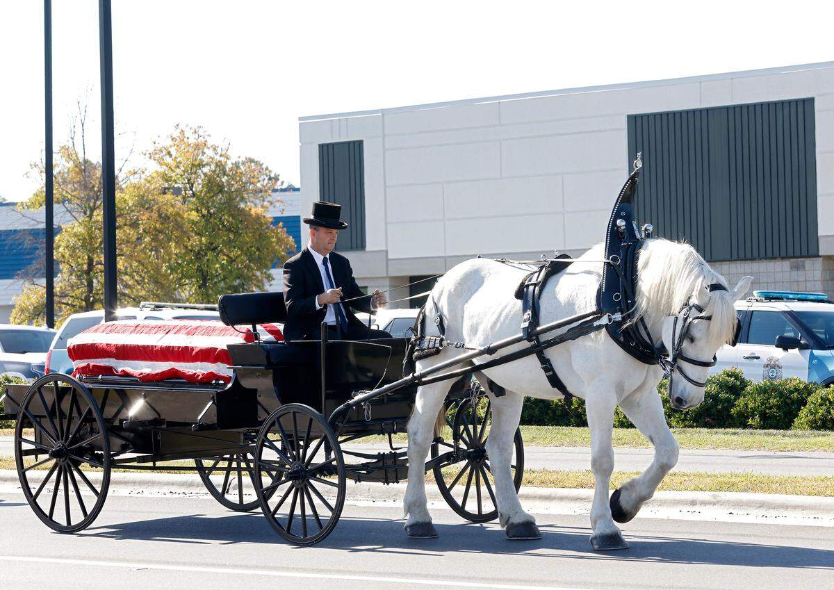 A funeral caisson processes on Yonkers Road on Saturday, Oct. 22, 2022, in Raleigh, N.C., prior to a funeral for Raleigh police officer Gabriel Torres, 29, who was one of five people fatally shot near the Hedingham neighborhood on Oct. 13.