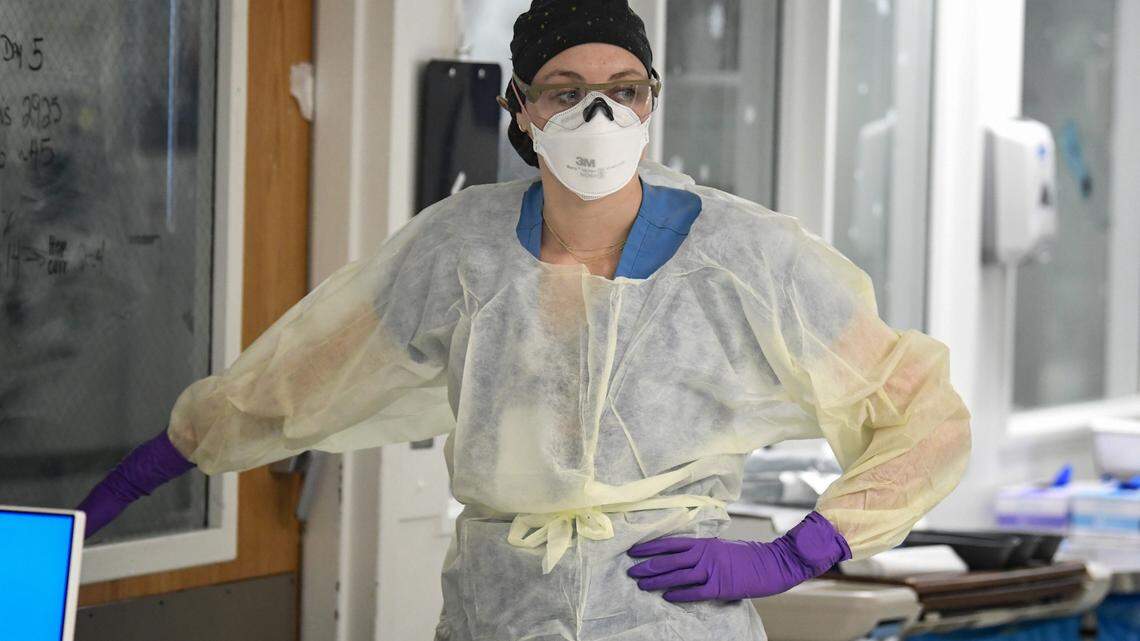 Registered nurse Katie Creran prepares to enter a COVID patient’s room in the Surgical Trauma ICU at UNC Hospital in Chapel Hill, N.C., Thursday, January 27, 2022.