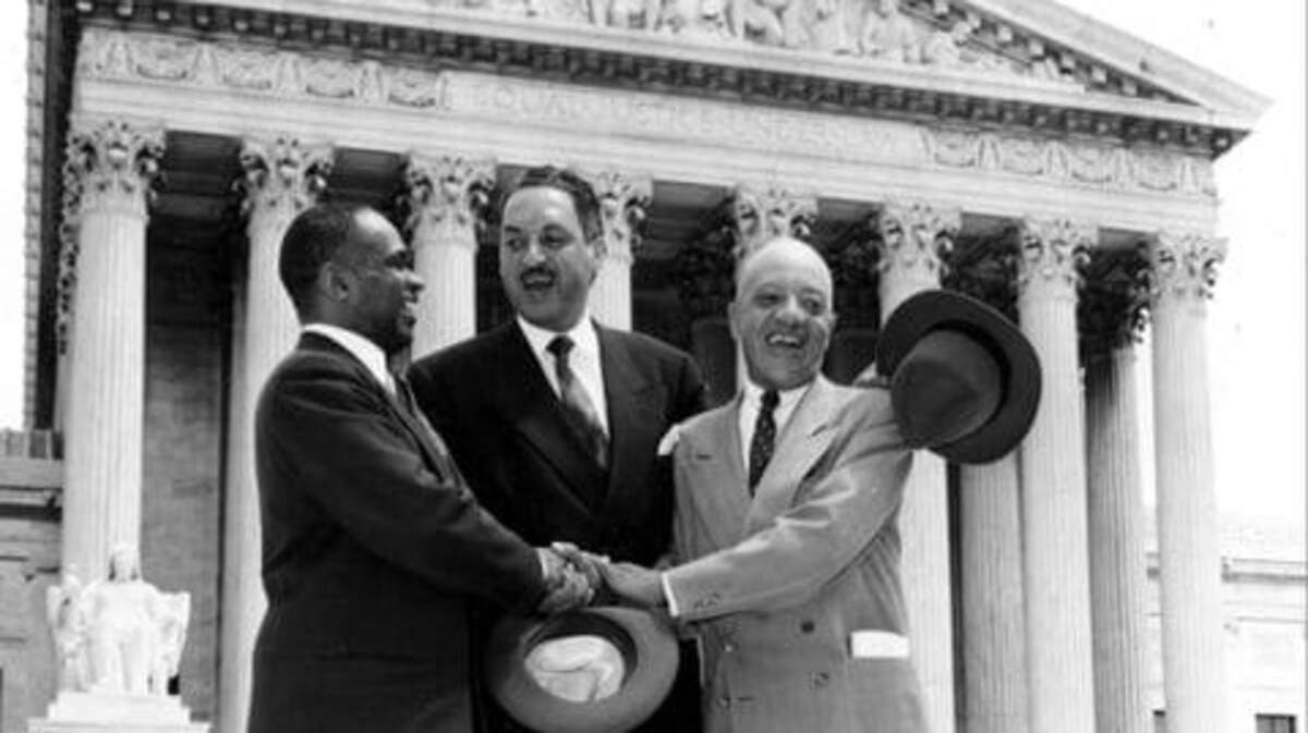 George E.C. Hayes, left, Thurgood Marshall and James M. Nabrit celebrate May 17, 1954, outside the Supreme Court following the ruling on Brown v. Board of Education. The unanimous decision in the case is widely seen as one of the high court’s greatest moments. (AP)