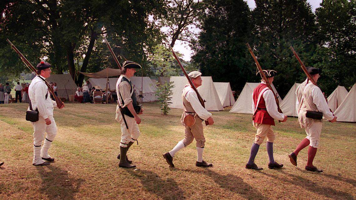 American Revolution re-enactors from the N.C. Highland Regiment march back to their campsite after "fighting" in a skirmish as the House in the Horseshoe in northern Moore County.  