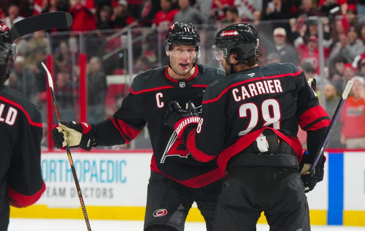 Carolina Hurricanes left wing William Carrier (28) celebrates a goal with center Jordan Staal (11) against the Columbus Blue Jackets during the first period at Lenovo Center.