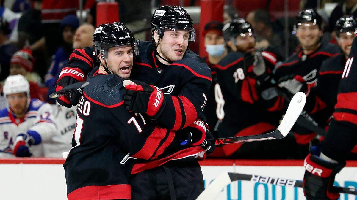 Carolina Hurricanes’ Jesper Fast, right, celebrates his goal with teammate Tony DeAngelo (77) during the second period of an NHL hockey game against the New York Rangers in Raleigh, N.C., Friday, Jan. 21, 2022. (AP Photo/Karl B DeBlaker)