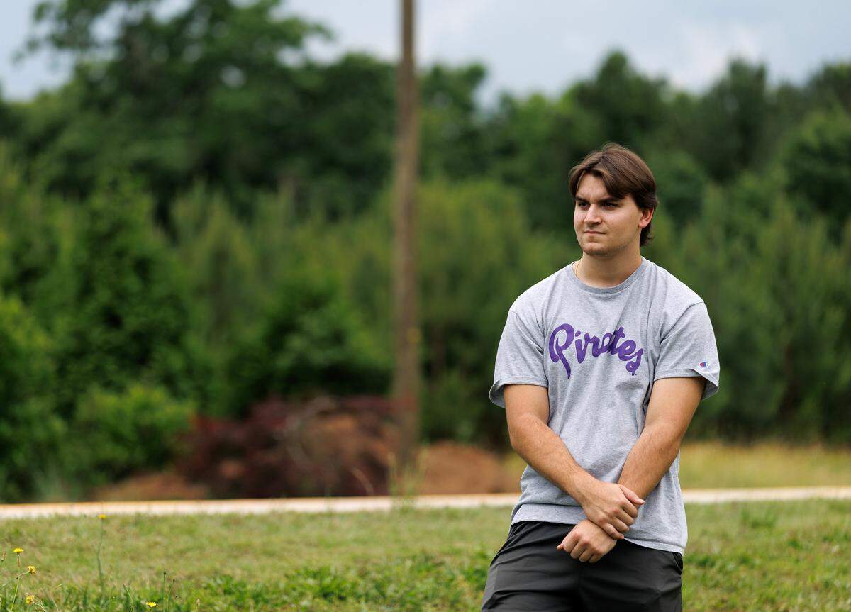 Nate Guido, 20, pictured on Wednesday, May 14, 2025, stands near the site of a hit-and-run motorcycle crash that killed his father on Turnipseed Road in Wake County.
